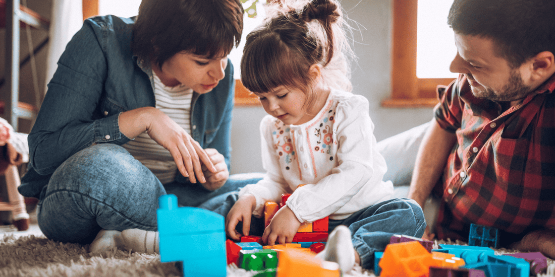 sweet daughter playing her toys with parents, co parenting success